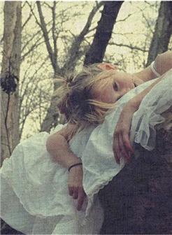 趴在枯树上的女生悲伤图片