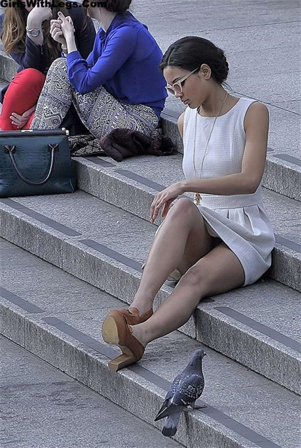 candid babe in pantyhose stretches out her long sexy legs